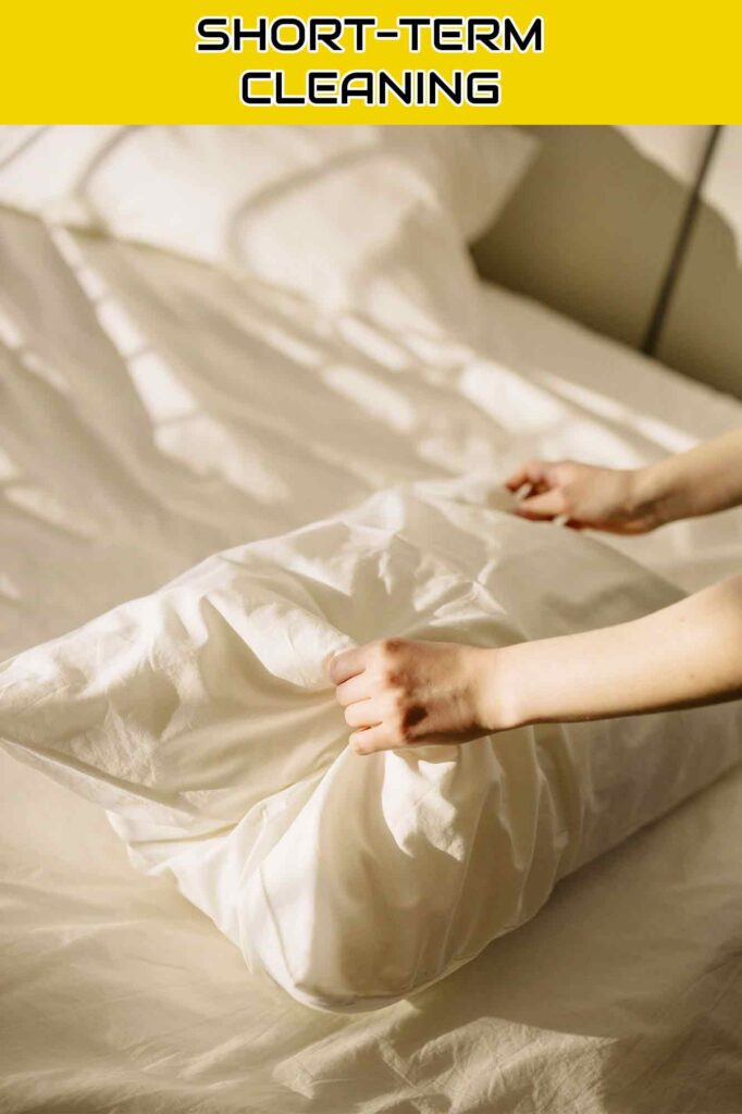 Professional touch: Woman placing a pillow on a bed - Bay Area Cleaning Services